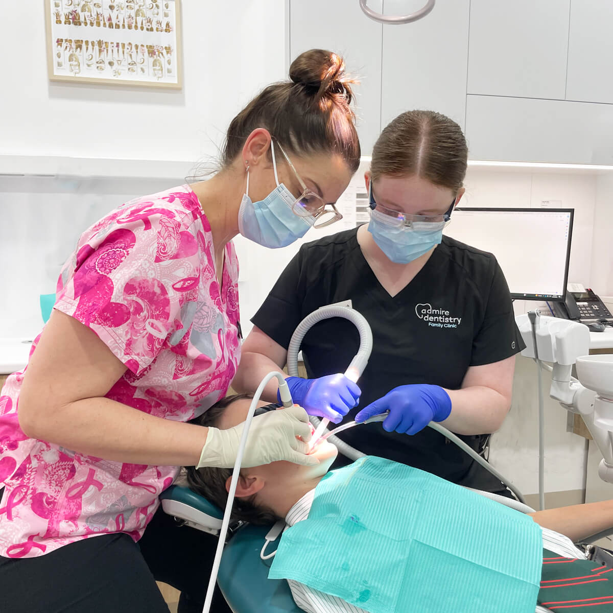 Oral Health Therapist Sarah performing a gentle dental cleaning for a patient at Admire Dentistry Arana Hills.